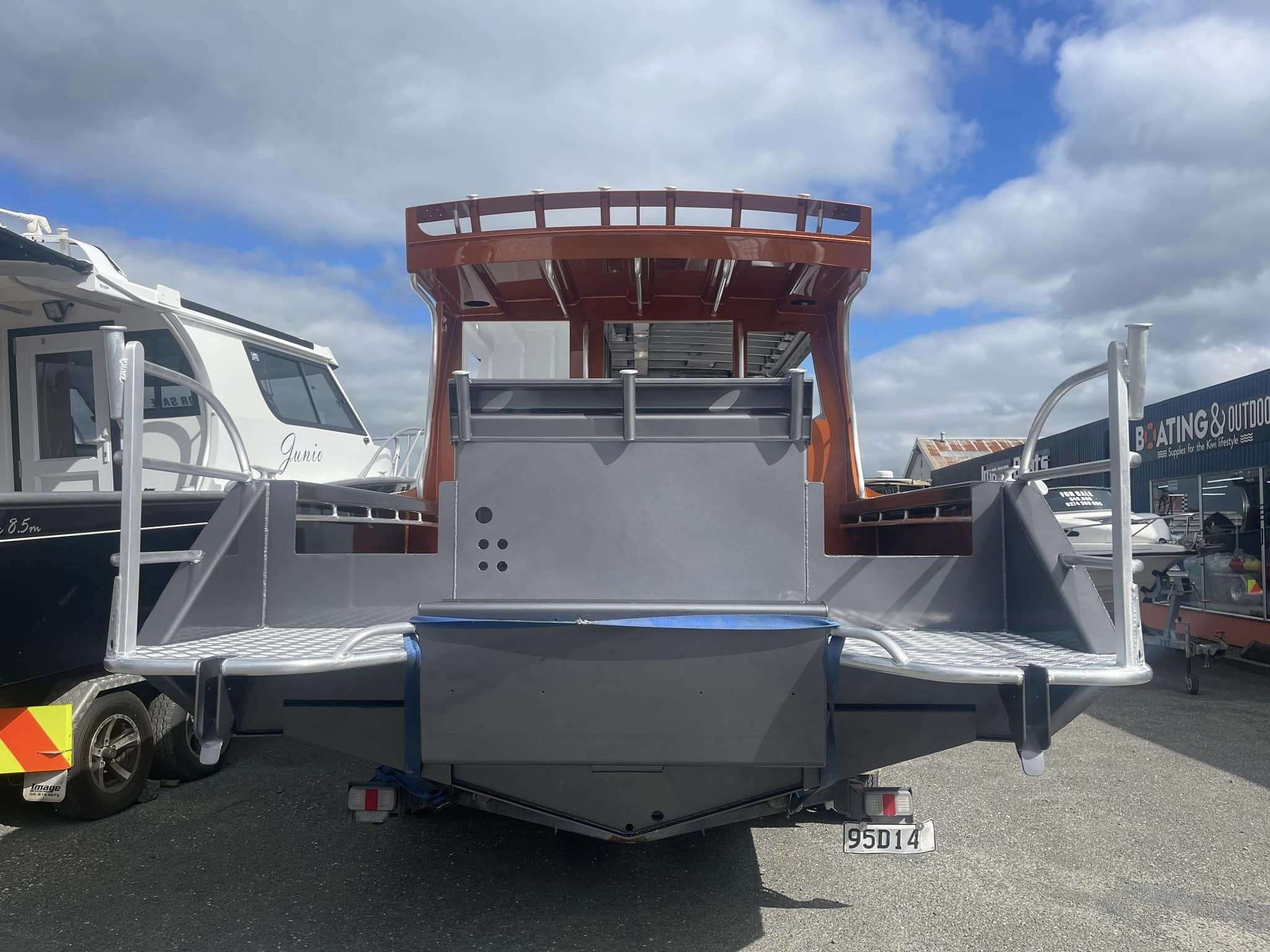 Image Boats NZ 8.0 Fishfinder Orange Boat parked view of back of boat